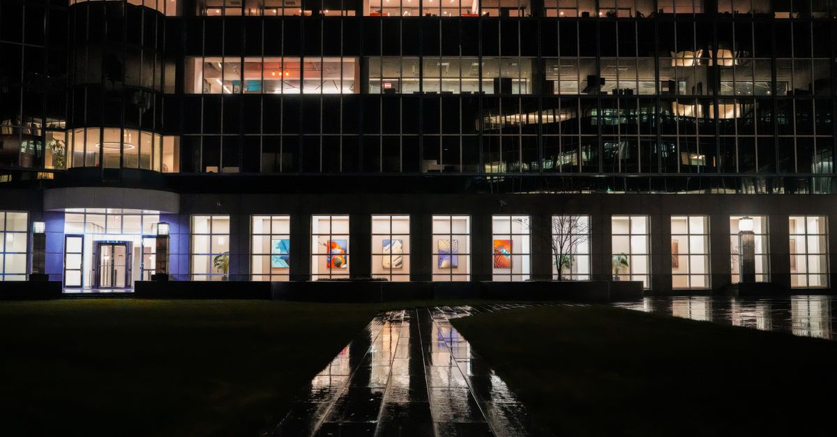 Dark outdoor office building with night reflections